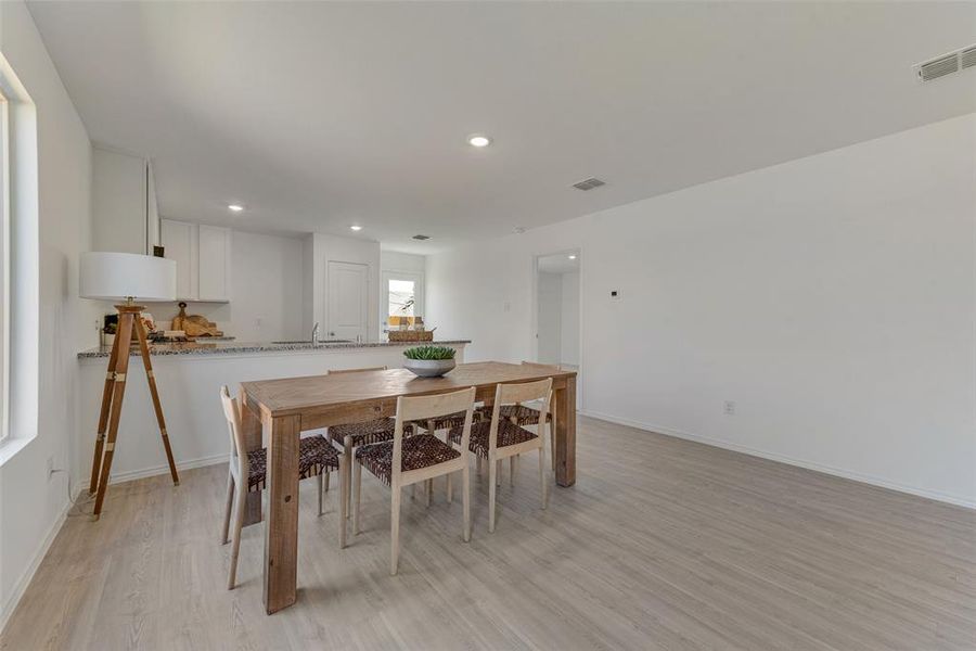 Dining room featuring light wood-type flooring and sink