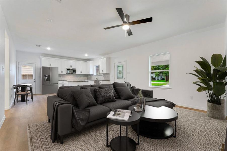 Living to Kitchen - The open layout allows the living room to transition seamlessly into the kitchen, creating a cohesive entertaining space.