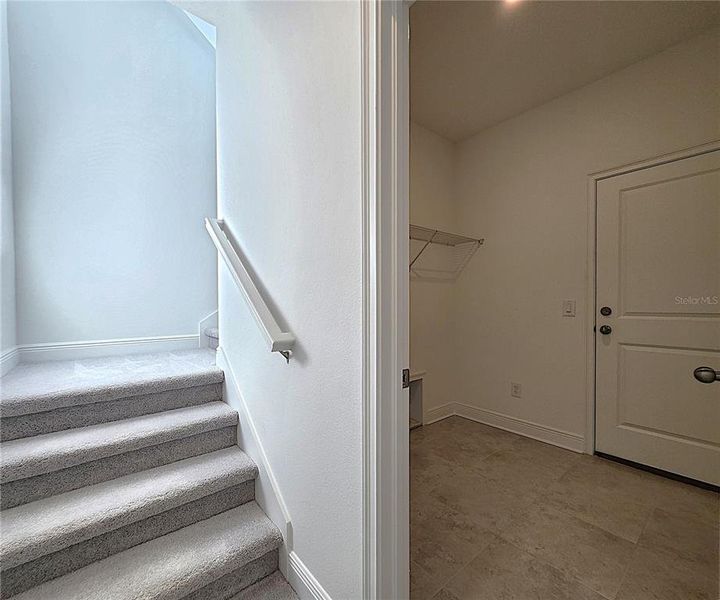 Laundry Room and stairs leading to the second level