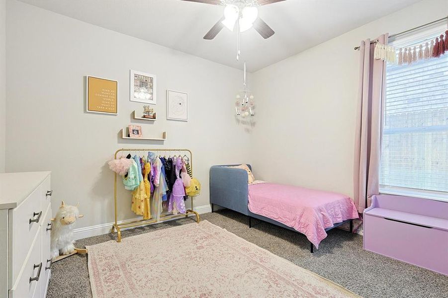 Large additional bedroom with natural light, and ceiling fan