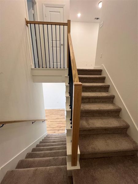 Stairway with dark colored carpet