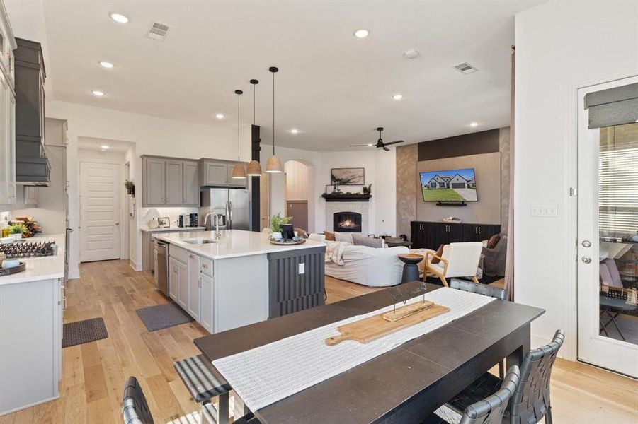 Dining room with light hardwood / wood-style flooring, ceiling fan, and sink