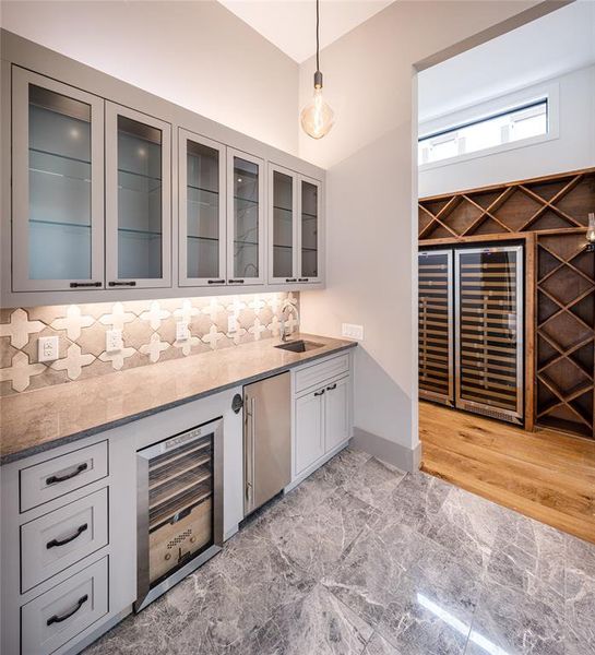 Wet Bar wine fridge, cigar humidor, scotsman "top hat" ice maker, under & above cabinet lighting and luxury tile flooring