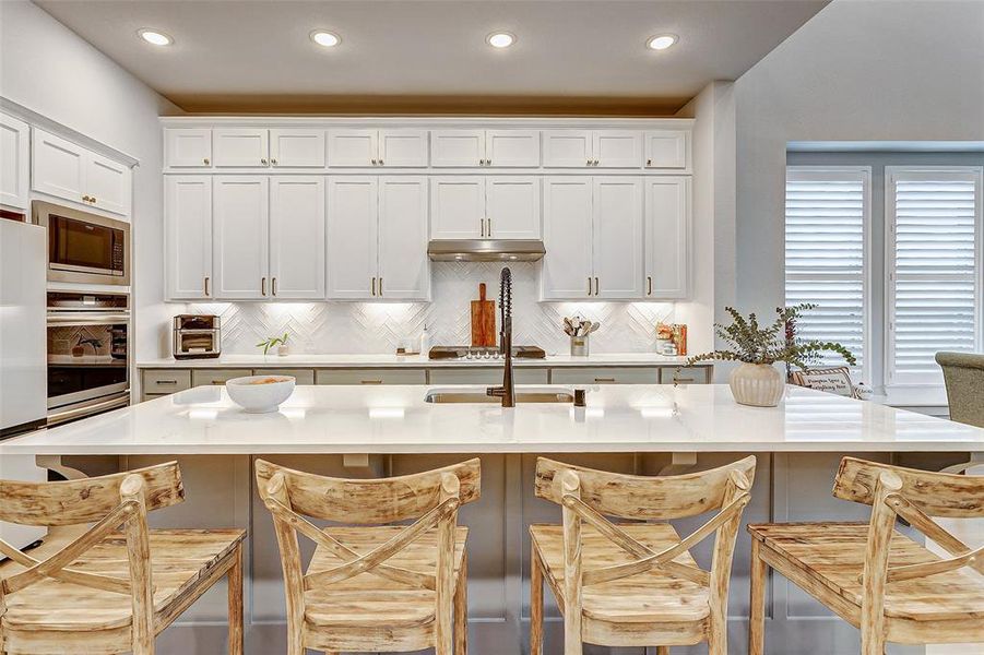 This gourmet kitchen is sure to impress with double stacked soft close cabinetry with under mount lighting.