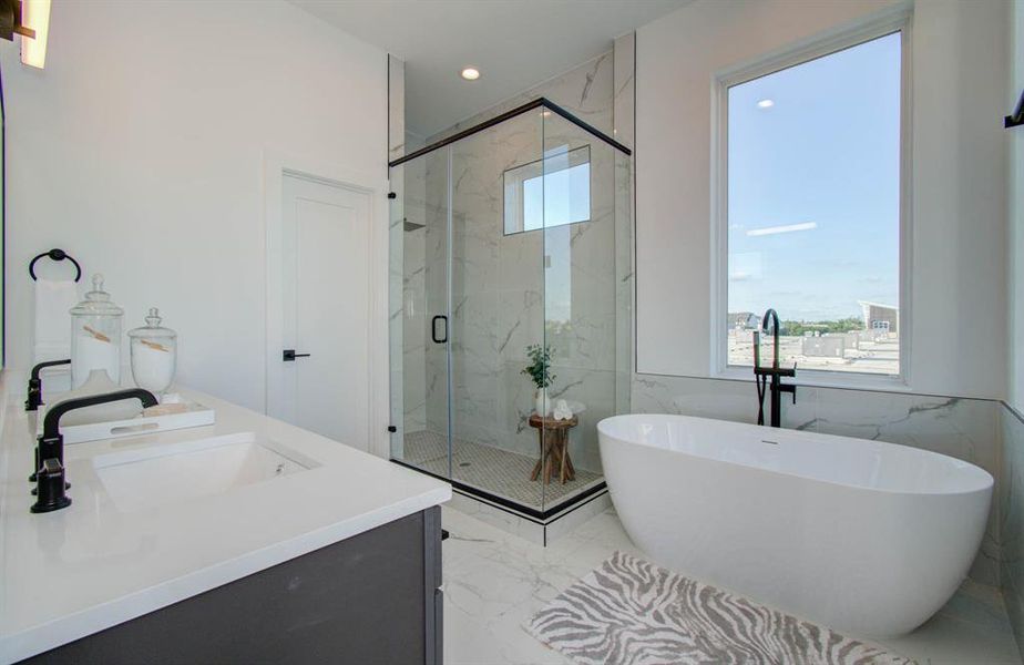 Huge walk-in shower, stand alone soaking tub and ample natural light