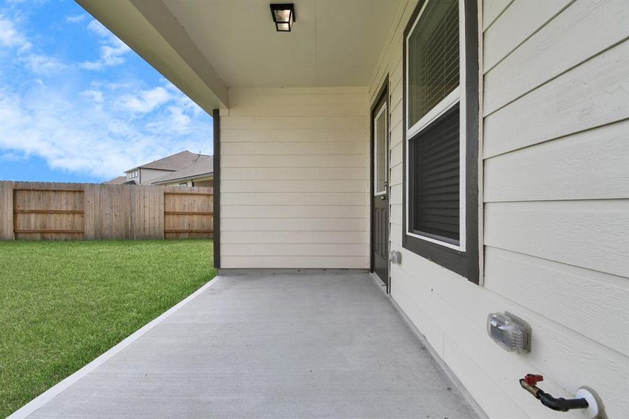 Explore the expansive backyard with its inviting covered patio—a perfect blend of space for the kids to play and adults to unwind. Sample photo of completed home with similar plan. Actual color and selections may vary.