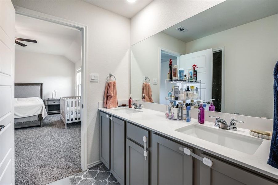 Bathroom featuring vanity, lofted ceiling, and ceiling fan