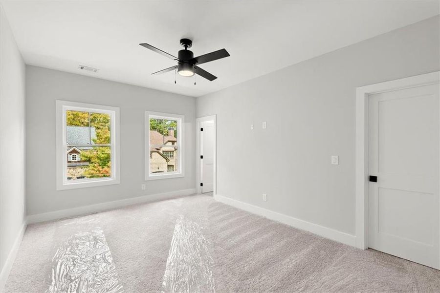 Spare room featuring ceiling fan and light colored carpet