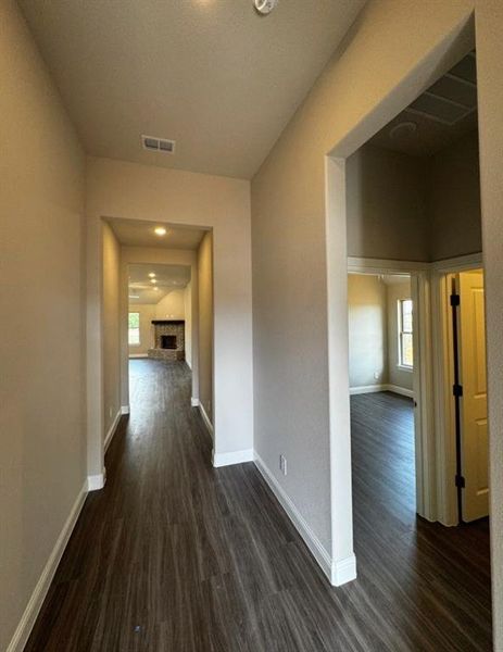 Hall with dark hardwood / wood-style flooring