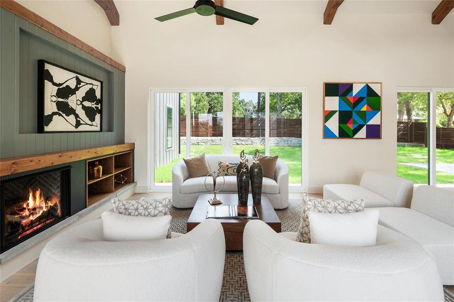 Living room featuring a healthy amount of sunlight, wood-type flooring, and beamed ceiling