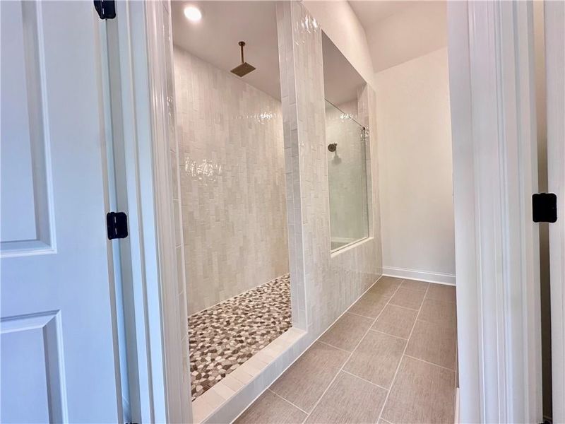 Conversation piece will be your owners walk-through shower complete with two rain showerheads