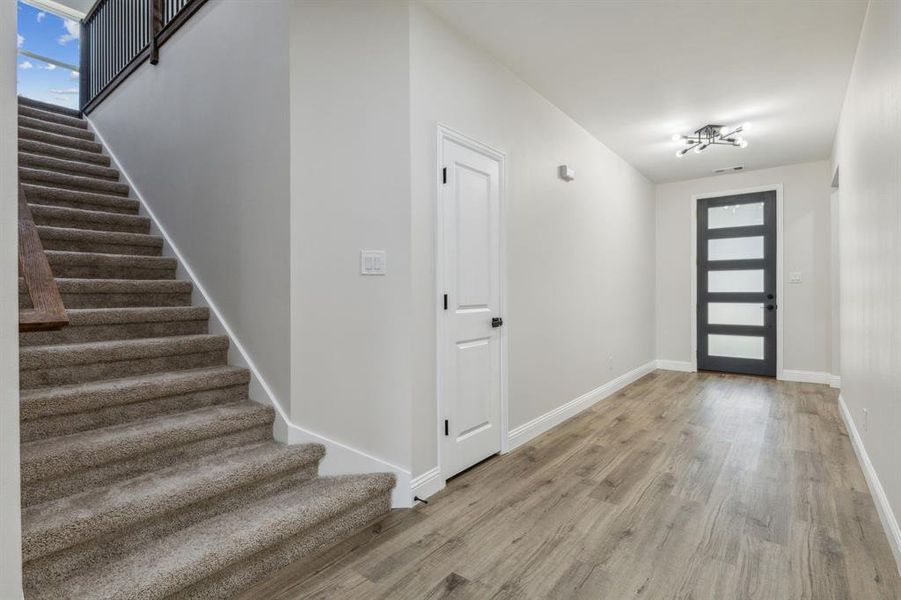 Foyer entrance with light hardwood / wood-style flooring