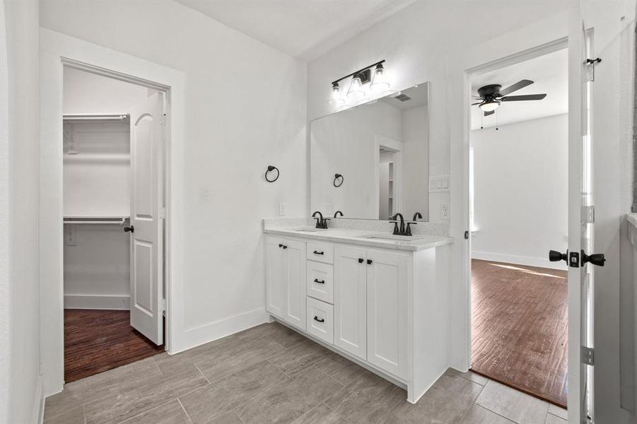 Bathroom featuring ceiling fan and vanity