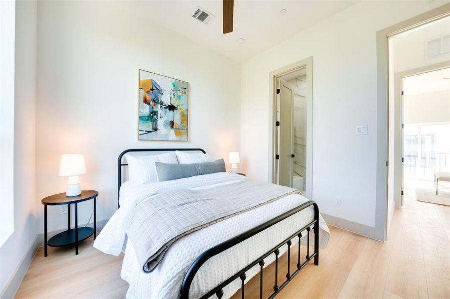 Bedroom with light hardwood / wood-style floors and ceiling fan