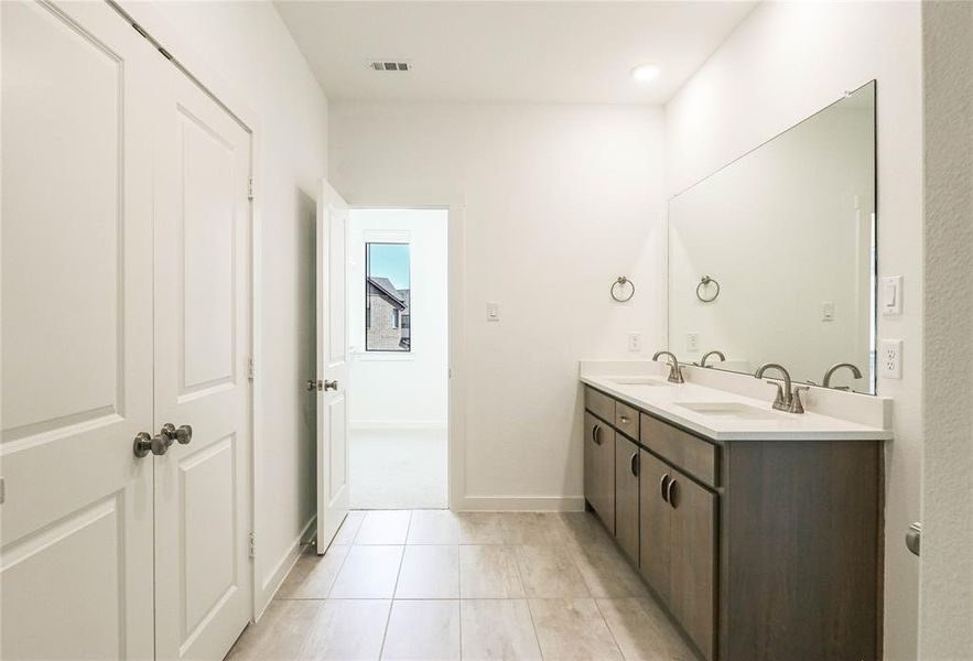 Ensuite master bath  with dual vanities and linen closet