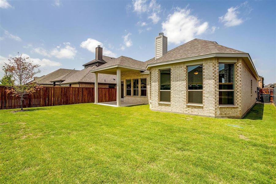 Back of house featuring a patio, a lawn, and cooling unit