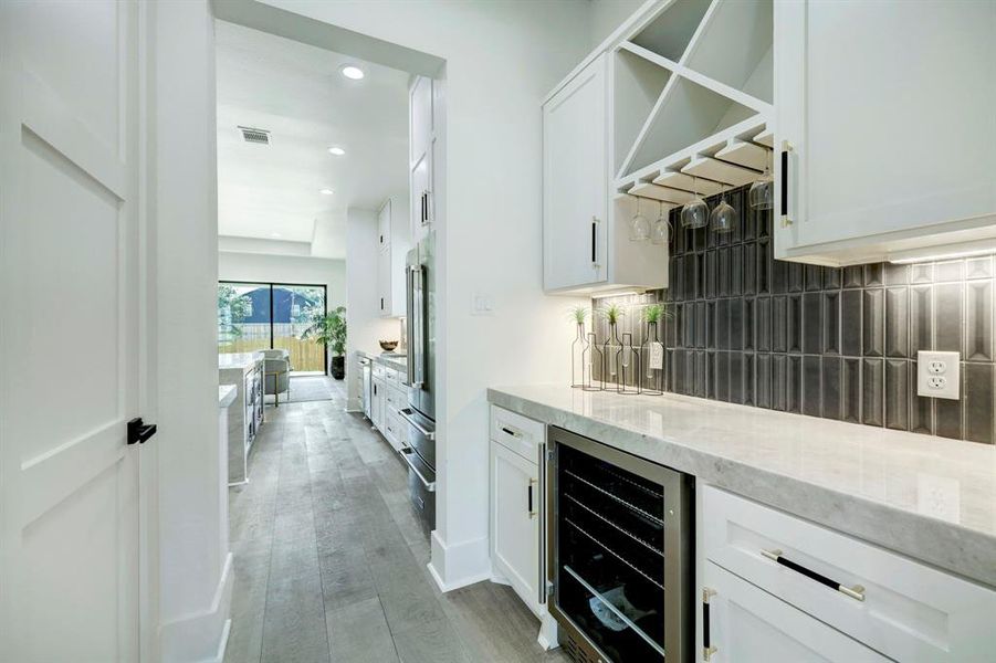 Butler's passthrough includes bev-cooler, wine storage and a large walk-in pantry.