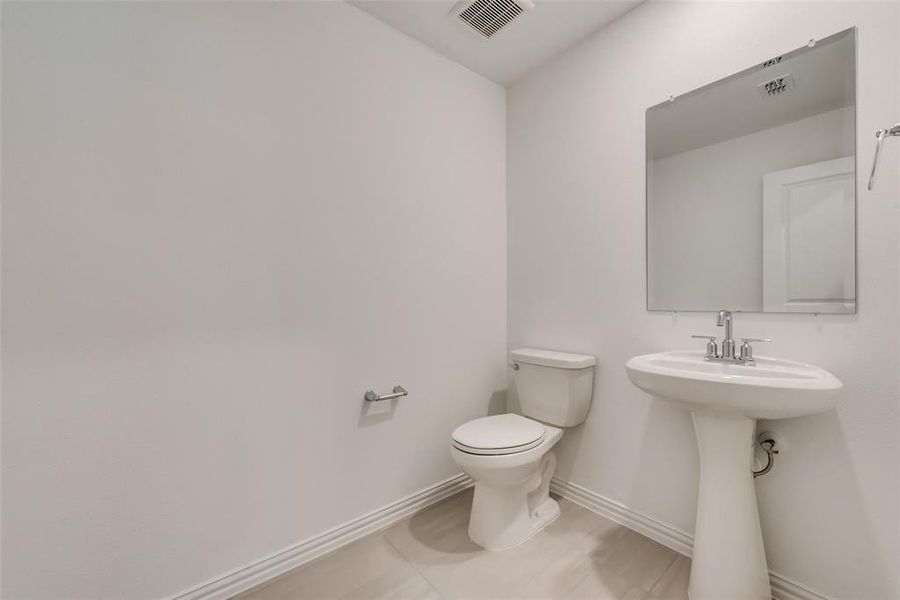 Bathroom with tile patterned floors and toilet