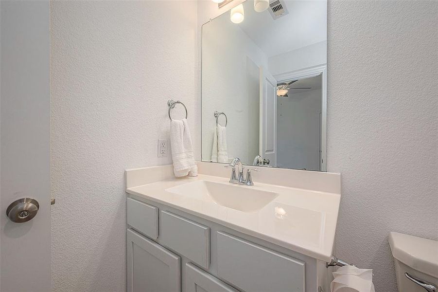 This bathroom provides a serene space to start your day with a simple sink and a large mirror for getting ready.