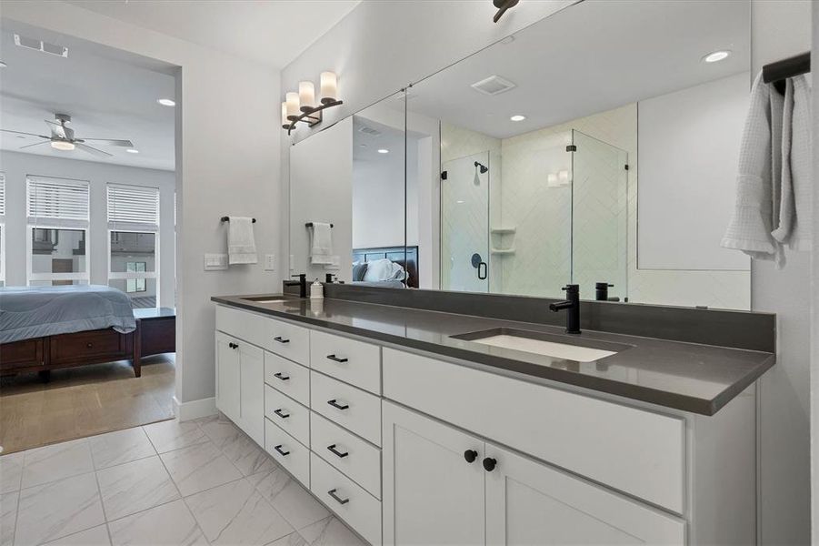 The spa-quality bath in the primary suite features dual vanities, ensuring plenty of space for morning routines
