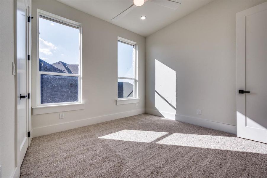 Unfurnished room with light carpet and ceiling fan