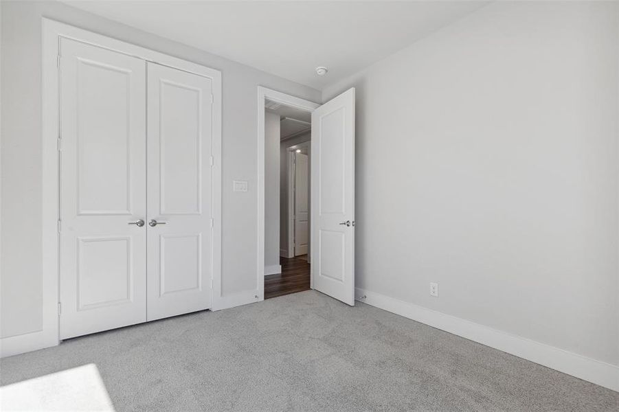 Unfurnished bedroom with carpet and a closet