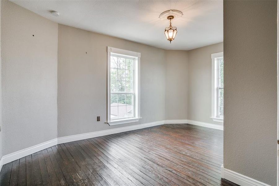 Unfurnished room featuring dark hardwood / wood-style floors