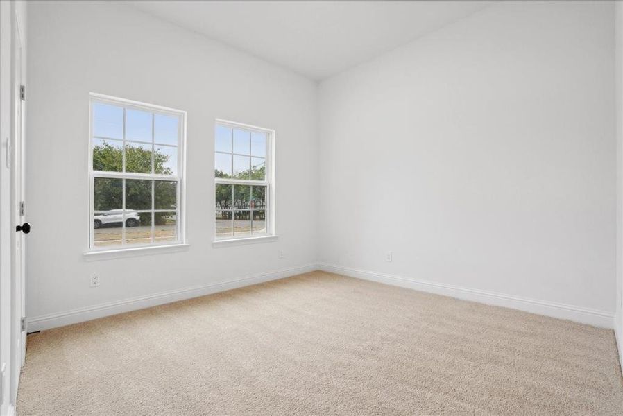 Bedroom 3 featuring light carpet