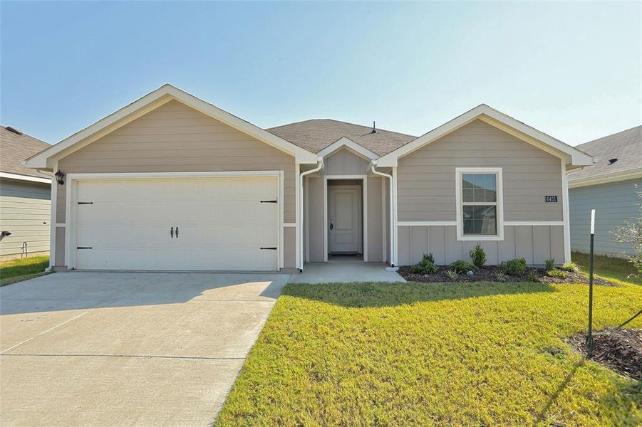 Ranch-style house with a garage and a front yard