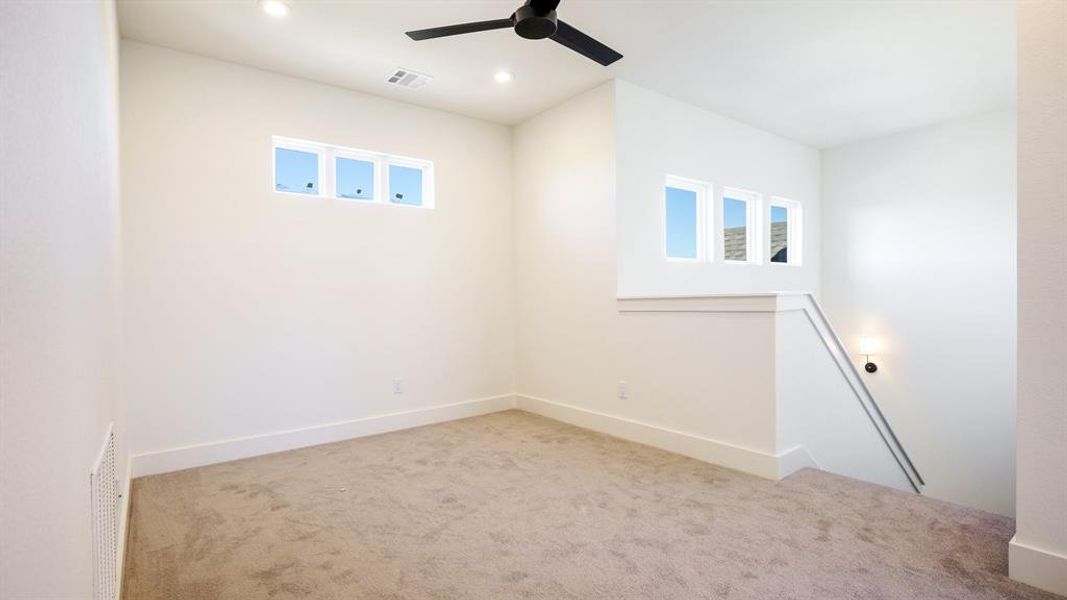 Unfurnished room with light carpet and ceiling fan