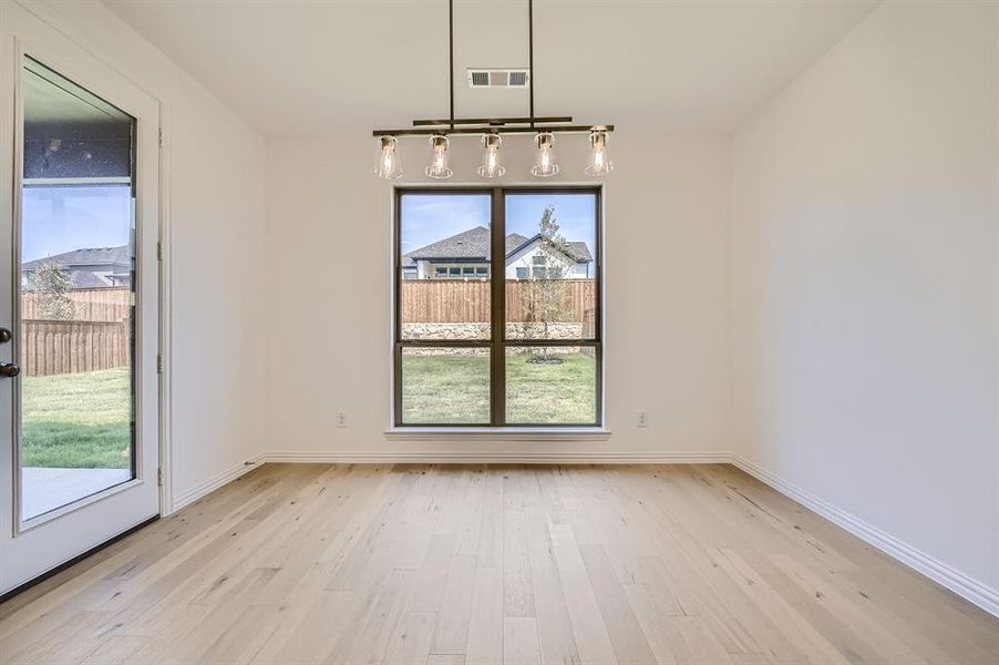 Unfurnished dining area featuring light hardwood / wood-style floors