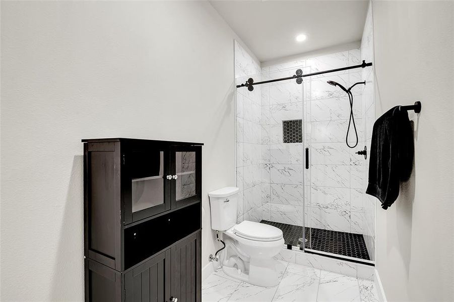 Bathroom featuring an enclosed shower and toilet