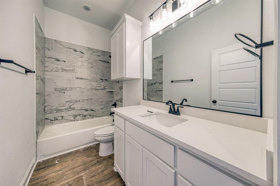 Tiled tub/shower combo in the 2nd hall bath.