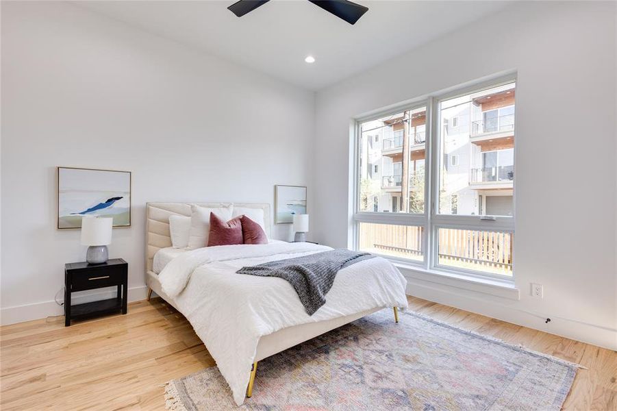 Bedroom with light wood-type flooring and ceiling fan