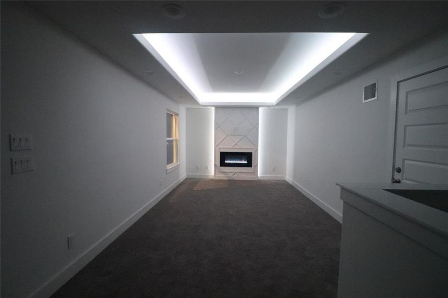 Large second floor den with accent wall, pre-wired for 5.1 surround sound, recessed 50" LED fire place w/ smart LED accent surround lighting, 9ft tray ceiling with smart LED lighting. Smart LED lights are compatible with amazon alexa and google assistant. These are real pictures not renderings.