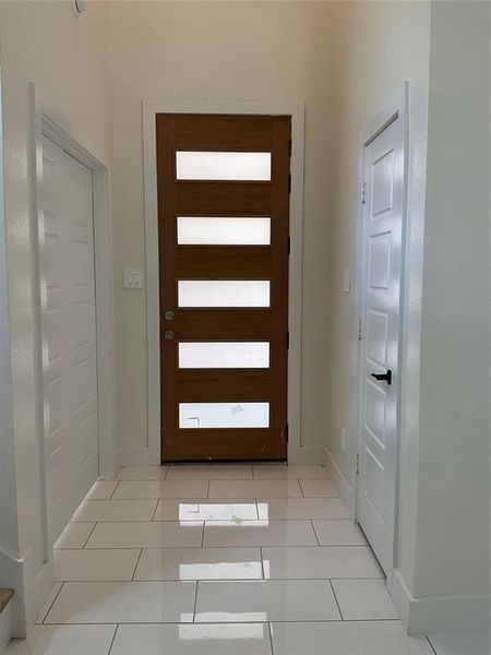 Doorway to outside with light tile patterned floors