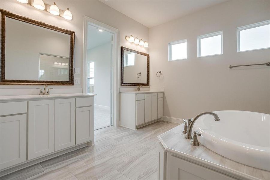 Bathroom with vanity and a tub