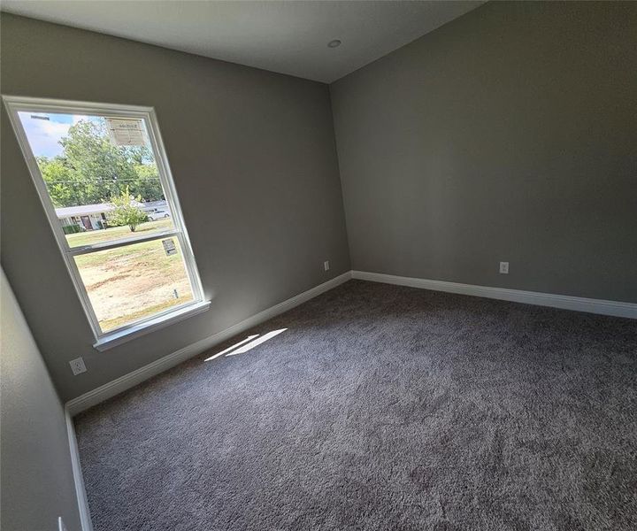 Empty room with plenty of natural light and carpet flooring