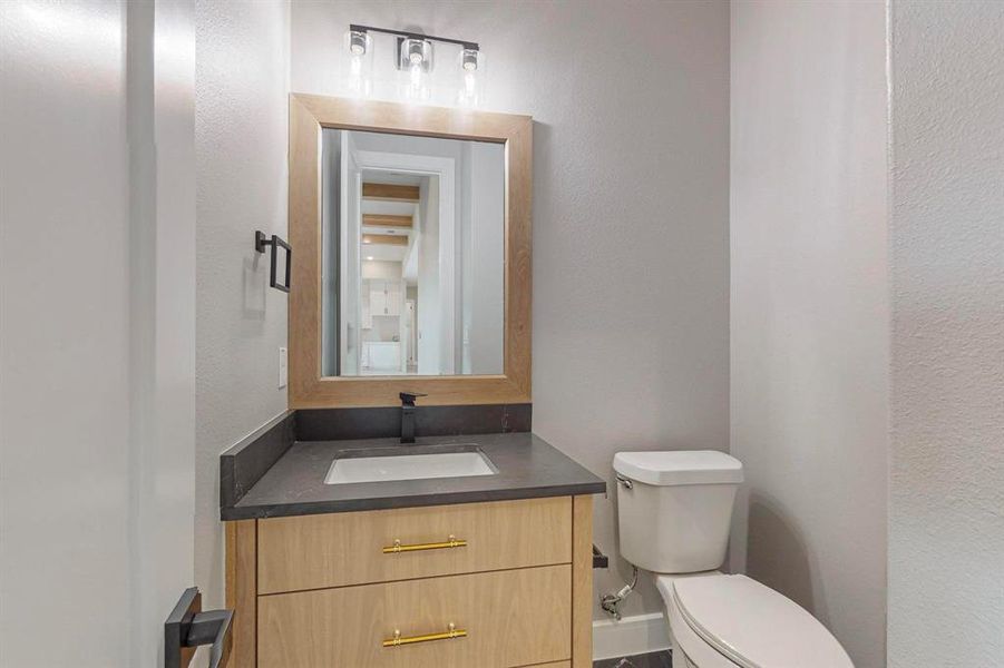 Bathroom featuring vanity and toilet