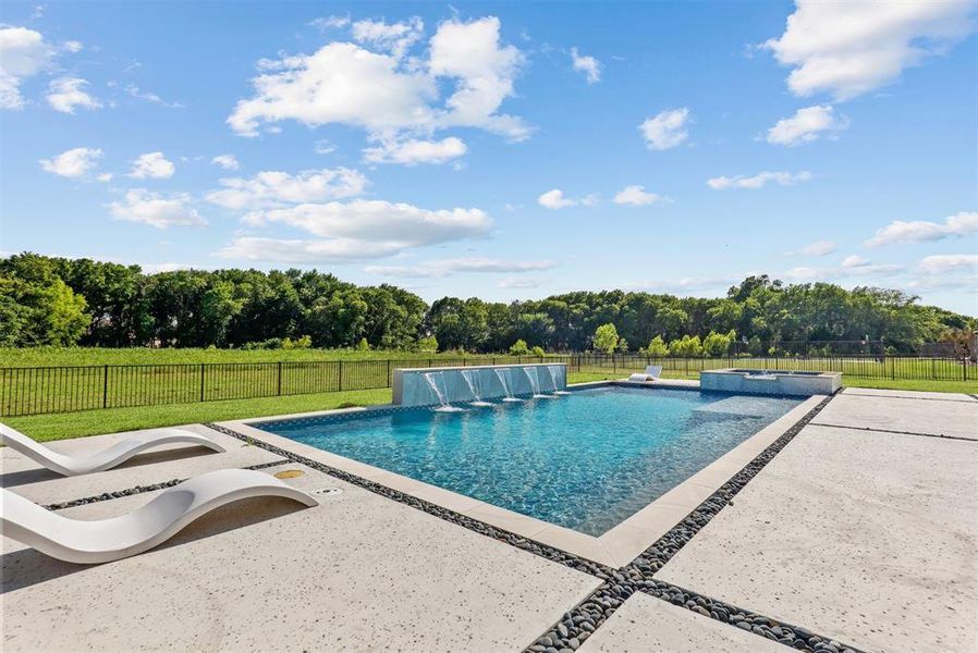 Sparkling pool overlooking your creek lot. Lots of room to expand