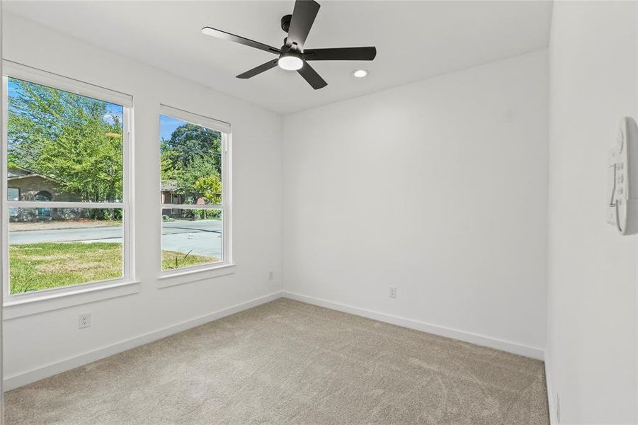 Spare room with ceiling fan and light colored carpet