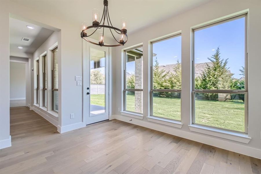 Doorway featuring light hardwood / wood-style flooring and an inviting chandelier