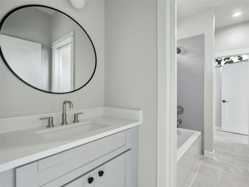 Bright and airy, the guest bathroom boasts ample natural light, creating an inviting atmosphere that ensures guests feel comfortable and at home during their stay.