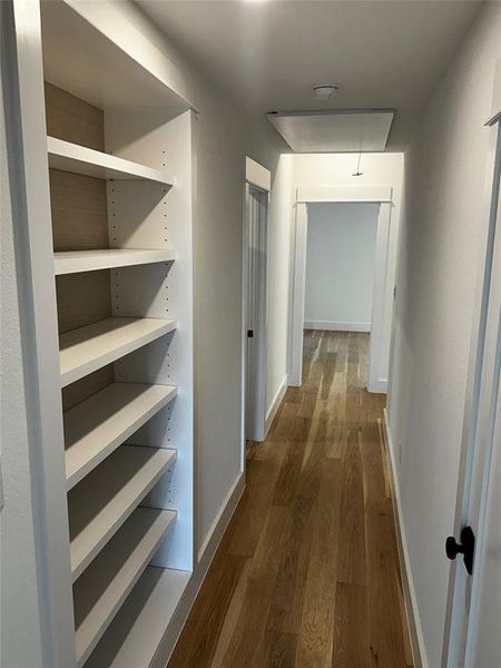 Built in bookcase hallway with paper backing. Not an inch of wasted space.