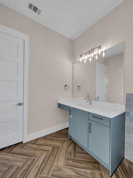 Bathroom featuring vanity and parquet flooring