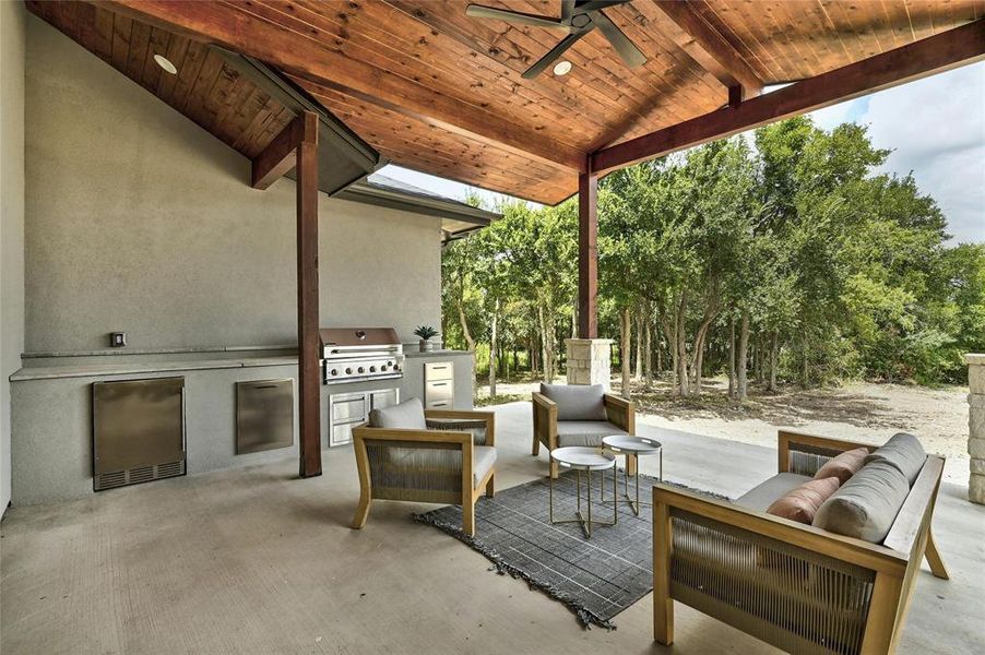 You will love spending your time in this beautiful outdoor living area.  BBQ island features 36in grill, refrigerator, storage drawers and trash/recycling receptacle.  Ceiling fan and recessed lighting are incorporated into expansive patio awning.