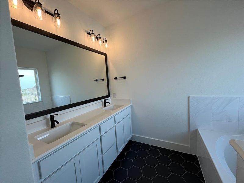 Masterbath loaded with features, framed mirrors, Black hardware/lighting, upscale floor tile and 5" baseboards