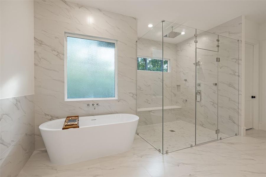 With quartz countertops, an abundance of storage including a linen closet, the primary bath is both beautiful and functional .