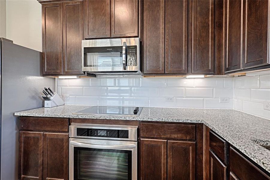 Stained cabinets, granite counters, stainless steel appliances