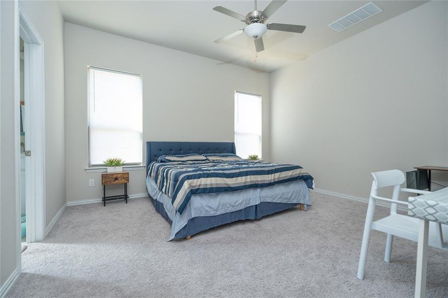 Bedroom with light carpet and ceiling fan